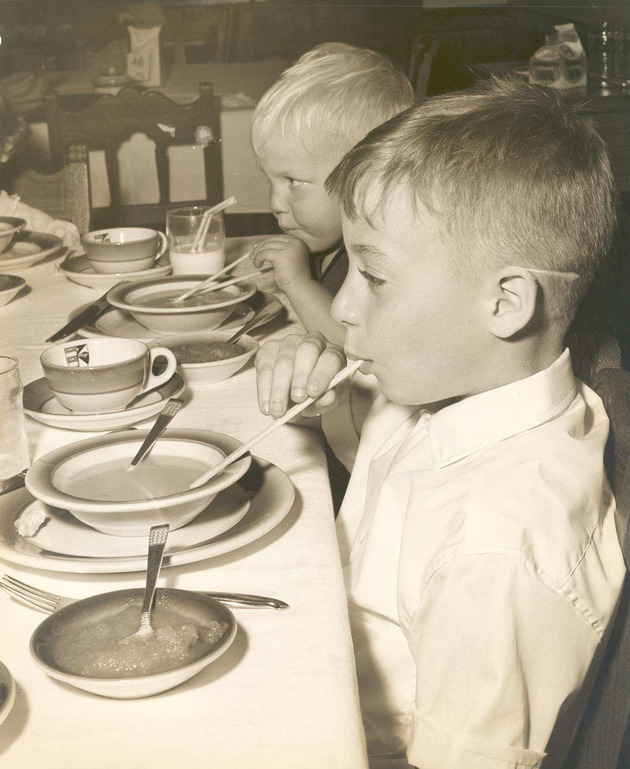 Children of James Barry eating during the Golden Jubilee for Monsignor William Barry